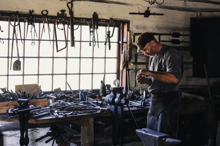 Welder wearing a pearl snap fr welding shirt while working in a welding station