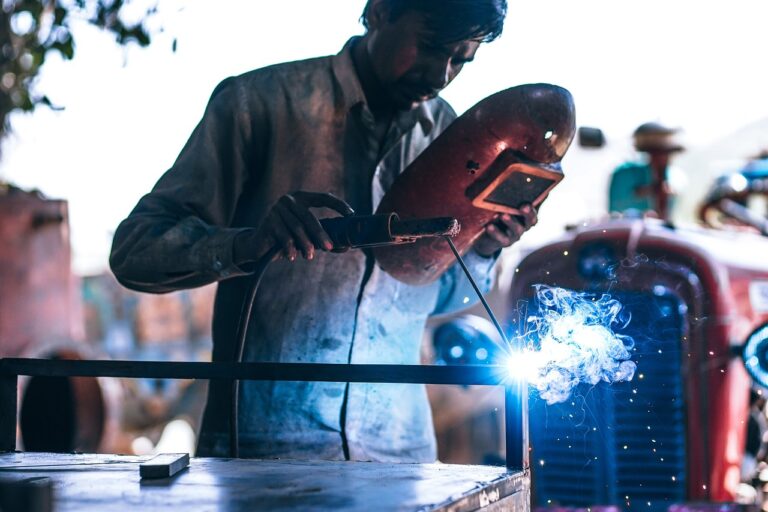 A man wearing black stallion fr clothing while welding in summer