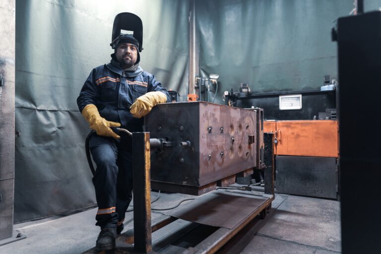 Welder standing wearing a starched welding shirt