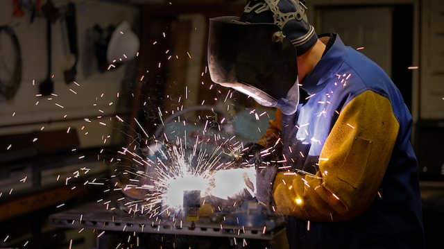 Man wearing a men's welding shirt and jacket while welding work